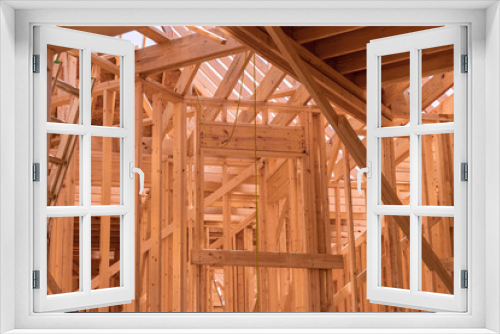 Fototapeta Naklejka Na Ścianę Okno 3D - New house construction with wooden beams the ceiling and wall system built frame