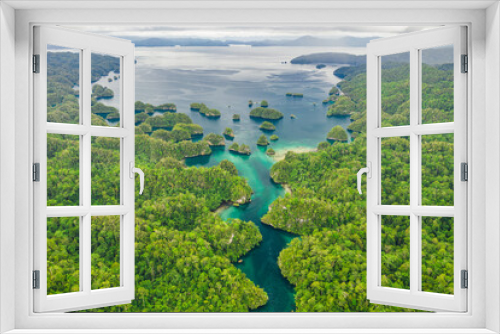 Fototapeta Naklejka Na Ścianę Okno 3D - The ocean lies at the end of the canal. High angle shot of a little islets and islands in the middle of Indonesia.