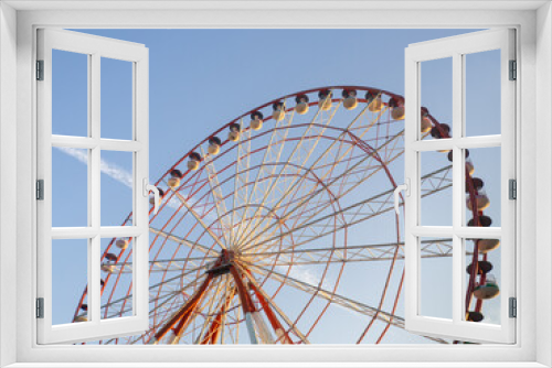 Fototapeta Naklejka Na Ścianę Okno 3D - Ferris wheel against the sky. Amusement park by the sea. Rest zone. Round mechanism. Height lovers.