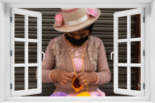 Fototapeta Naklejka Na Ścianę Okno 3D - Portrait of a Peruvian woman sewing with wool. Working on the street with a wool pompom.