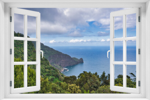 Fototapeta Naklejka Na Ścianę Okno 3D - A beautiful scenic view of the coast and mountains of Madeira. Clouds, sea, flowers in spring. Madeira, Portugal.