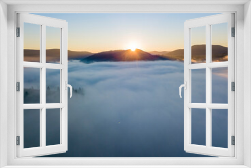 Fototapeta Naklejka Na Ścianę Okno 3D - Sunrise over the fog in the Ukrainian Carpathians. Aerial drone view.