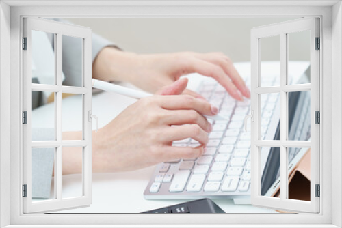 Fototapeta Naklejka Na Ścianę Okno 3D - A woman's hand hitting a computer keyboard