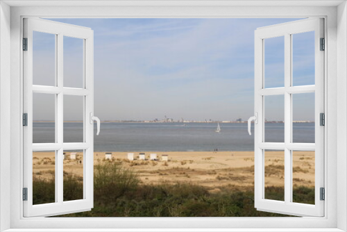 Fototapeta Naklejka Na Ścianę Okno 3D - a dutch coast landscape in breskens with a sand beach with beach houses and dunes and flushing at the other side of the westerschelde sea