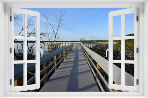 Fototapeta Naklejka Na Ścianę Okno 3D - Boardwalk on West Lake in Everglades National Park, Florida recently reopened after extensive repairs following Hurricane Irma damage, at sunrise.