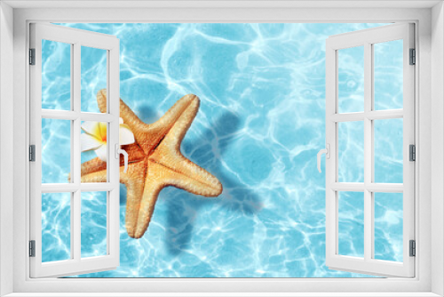 Fototapeta Naklejka Na Ścianę Okno 3D - Starfish and flower on the summer beach in sea water. Summer background.