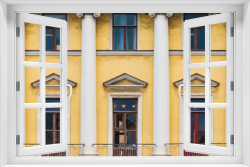 Fototapeta Naklejka Na Ścianę Okno 3D - Columns and several windows in a row on the facade of the urban historic apartment building front view, Saint Petersburg, Russia
