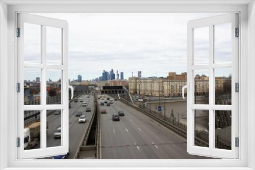 Fototapeta Naklejka Na Ścianę Okno 3D - Beautiful old buildings. Overcast weather. Business center Moscow city in the distance. Highway with cars