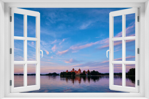 Fototapeta Naklejka Na Ścianę Okno 3D - Trakai Island Castle in lake Galve, Lithuania on sunset with dramatic sky reflecting in water. Trakai Castle is one of major tourist attractions of Lituania