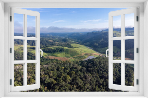 Fototapeta Naklejka Na Ścianę Okno 3D - Beautiful country town with beautiful mountain on the horizon and green fields in nature - Pedra Azul, Espirito Santo, Brazil