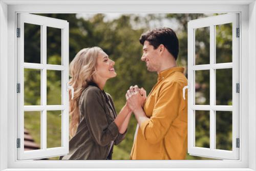 Profile side view portrait of beautiful handsome tender couple holding hands pastime honey moon outdoors