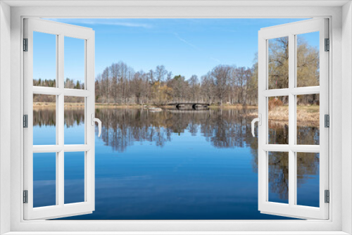 Fototapeta Naklejka Na Ścianę Okno 3D - Calm lake reflection in springin a sunny day.