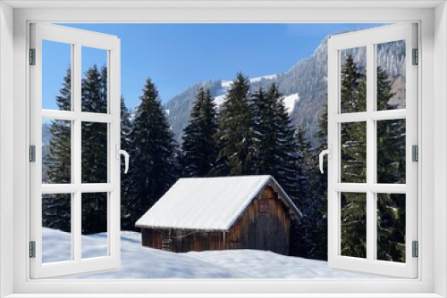 Fototapeta Naklejka Na Ścianę Okno 3D - Indigenous alpine huts and wooden cattle stables on Swiss pastures covered with fresh white snow cover, Nesslau - Obertoggenburg, Switzerland (Schweiz)