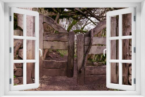 Fototapeta Naklejka Na Ścianę Okno 3D - An old wooden gate in the forest path. Mystical background.
