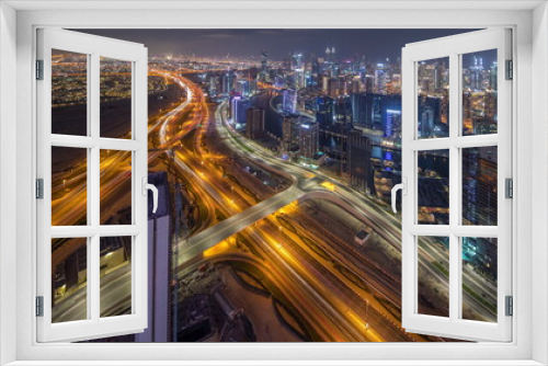 Fototapeta Naklejka Na Ścianę Okno 3D - Panorama showing skyline of Dubai with business bay and downtown district night timelapse.