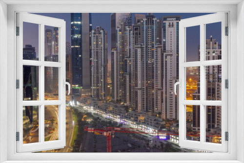 Fototapeta Naklejka Na Ścianę Okno 3D - Bay Avenue with modern towers residential development in Business Bay aerial night to day timelapse, Dubai
