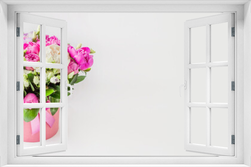 Fototapeta Naklejka Na Ścianę Okno 3D - bouquet of flowers in a hat box web banner. Bouquet of peonies, eustoma, spray rose in a pink box with an oasis on a white background with copy space