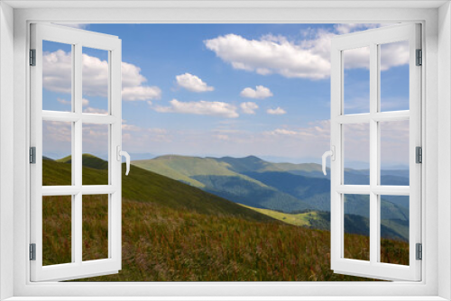 Fototapeta Naklejka Na Ścianę Okno 3D - Summer natural landscape of a mountain range covered with dense forest and alpine green grassy meadows. Carpathian Mountains, Ukraine