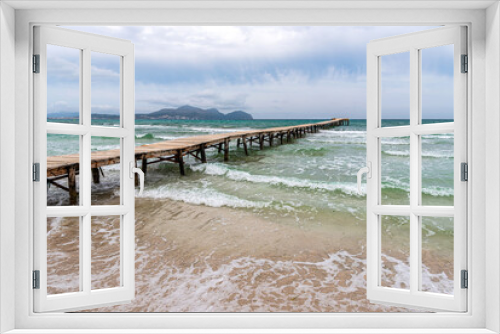 Fototapeta Naklejka Na Ścianę Okno 3D - Majorca. Platja de Muro beach on a cloudy day. Wooden platform in the sea