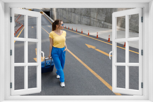 woman moving on road with suitcase