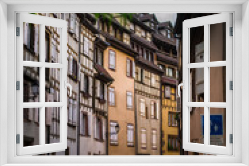 Fototapeta Naklejka Na Ścianę Okno 3D - historical wooden half-timbered architecture of the alsace town on the river bank
