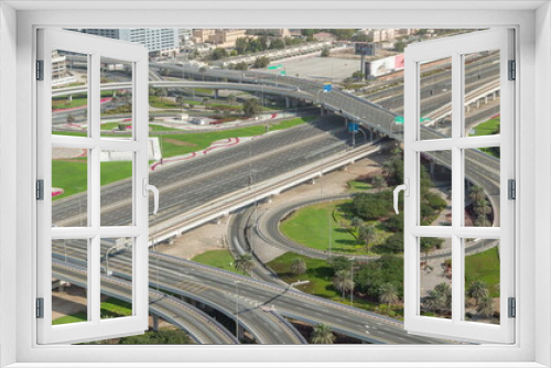 Fototapeta Naklejka Na Ścianę Okno 3D - Aerial view on Dubai Marina with big highway intersection timelapse and skyscrapers around, UAE