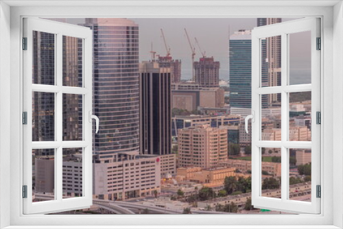Fototapeta Naklejka Na Ścianę Okno 3D - Office buildings in Dubai Internet City and Media City district aerial night to day timelapse