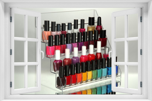 Fototapeta Naklejka Na Ścianę Okno 3D - Bright nail polishes on shelf on grey background
