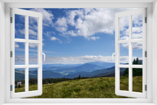 Fototapeta Naklejka Na Ścianę Okno 3D - Beautiful landscape of highland in Carpathians, Ukraine. View from top on mountain slope with dry vegetation and several cottages on down hill in autumn, with copy space. Concept of travelling.