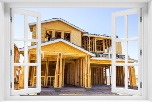 Fototapeta Naklejka Na Ścianę Okno 3D - New Multi Story Home Under Construction With Roofing Tile