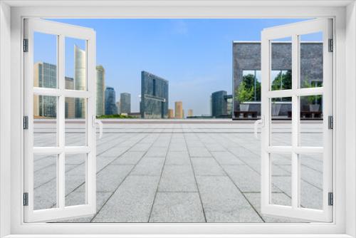 Fototapeta Naklejka Na Ścianę Okno 3D - Empty square floor and city skyline with modern commercial buildings in Hangzhou, China.