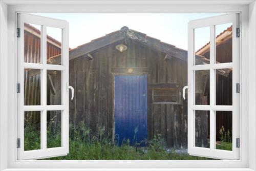 Fototapeta Naklejka Na Ścianę Okno 3D - oyster farmer wooden hut with blue door