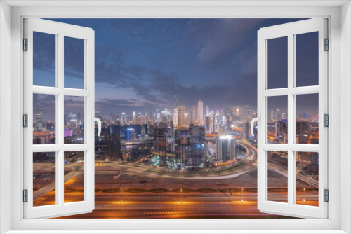 Fototapeta Naklejka Na Ścianę Okno 3D - Panoramic skyline of Dubai with business bay and downtown district day to night timelapse.