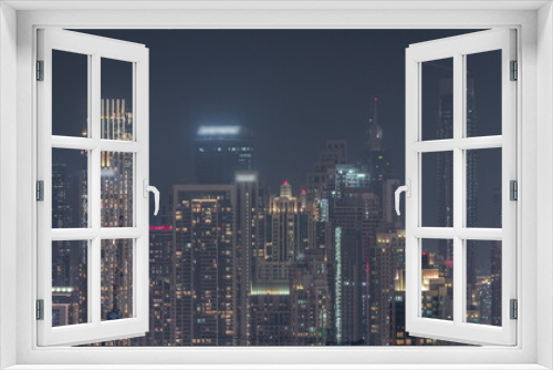 Fototapeta Naklejka Na Ścianę Okno 3D - Panoramic skyline of Dubai with business bay and downtown district night timelapse.