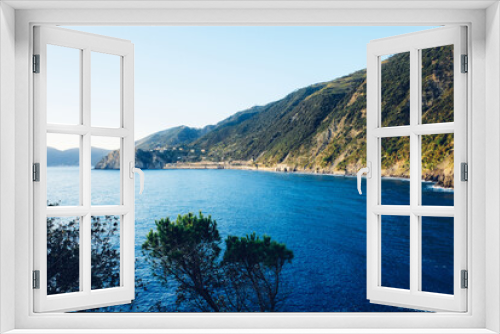 Fototapeta Naklejka Na Ścianę Okno 3D - Beautiful seascape with blue sky, smooth water surface and rocky cliffs in Liguria coastal area. Popular italian travel destination.