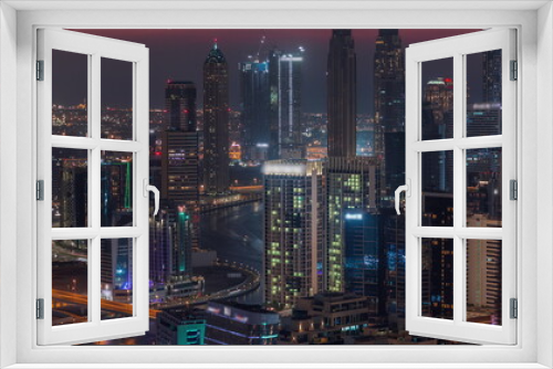 Fototapeta Naklejka Na Ścianę Okno 3D - Skyline with modern architecture of Dubai business bay towers day to night timelapse. Aerial view