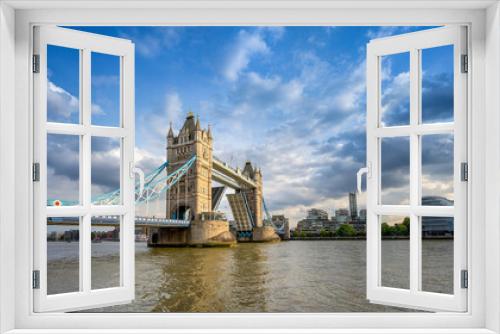 Fototapeta Naklejka Na Ścianę Okno 3D - the open tower bridge of london against a dramatic sky