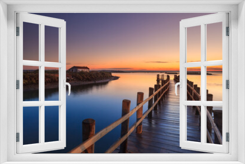 Fototapeta Naklejka Na Ścianę Okno 3D - Amazing romantic view from the pier at sunset. Serene landscape on the lake at colorful sunset. Old wooden pier in a fineart photo