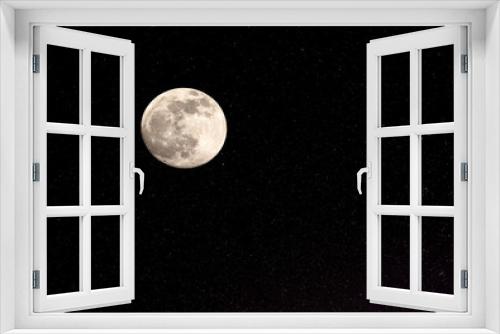 Fototapeta Naklejka Na Ścianę Okno 3D - Full moon and stars against a black night sky.