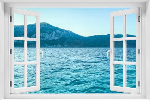Fototapeta Naklejka Na Ścianę Okno 3D - Coast. beauty of the sea, holidays in hot countries. next to the sea are high mountains in greenery and shrubs. blue waves of the sea