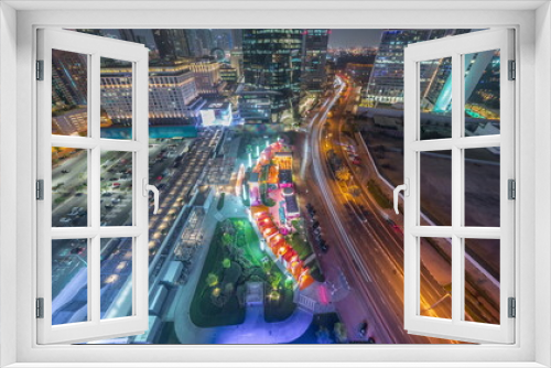 Fototapeta Naklejka Na Ścianę Okno 3D - Dubai International Financial district aerial night timelapse. Panoramic view of business and financial office towers.