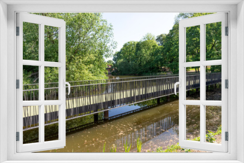Fototapeta Naklejka Na Ścianę Okno 3D - New iron bridge over the pond in the park