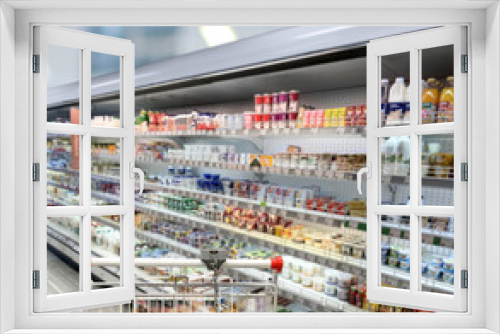 choosing a dairy products at supermarket.empty grocery cart in an empty supermarket