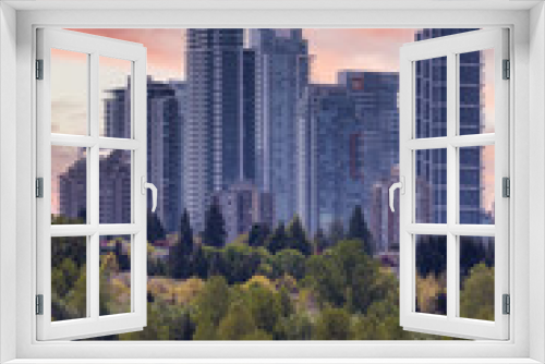 Fototapeta Naklejka Na Ścianę Okno 3D - View of Residential Apartment Home Buildings in Metrotown. Green Trees in Deer Lake Park, Burnaby, Vancouver, BC, Canada. Sunset Sky Art Render