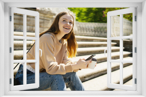 A female blogger uses her phone to write a message on a social network.