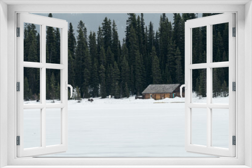 Fototapeta Naklejka Na Ścianę Okno 3D - Cabin on Lake Louise, Banff National Park with the frozen lake and snow capped mountains
