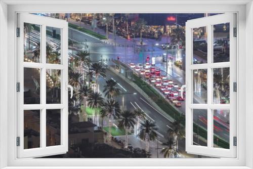 Fototapeta Naklejka Na Ścianę Okno 3D - Bussy traffic on the road intersection in Dubai downtown aerial night timelapse, UAE
