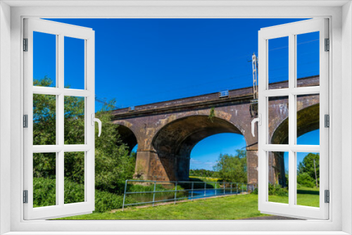 Fototapeta Naklejka Na Ścianę Okno 3D - A view of towards the viaduct over the river Great Ouse at Wolverton, UK in summertime