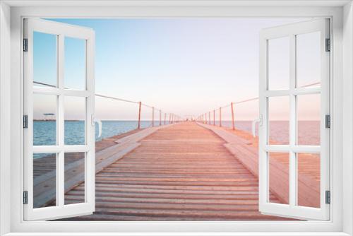 Fototapeta Naklejka Na Ścianę Okno 3D - Wooden pier near the blue sea.