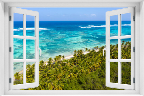 Fototapeta Naklejka Na Ścianę Okno 3D - Bounty and pristine tropical shore with coconut palm trees and turquoise caribbean sea. Beautiful landscape. Aerial view